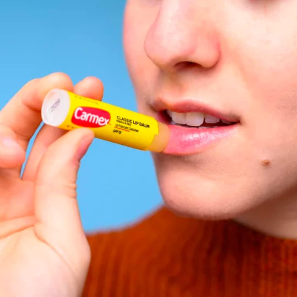 Carmex Daily Care Moisturizing Lip Balm Stick in strawberry flavor with SPF 15, 4.25g, for nourishing lip hydration.