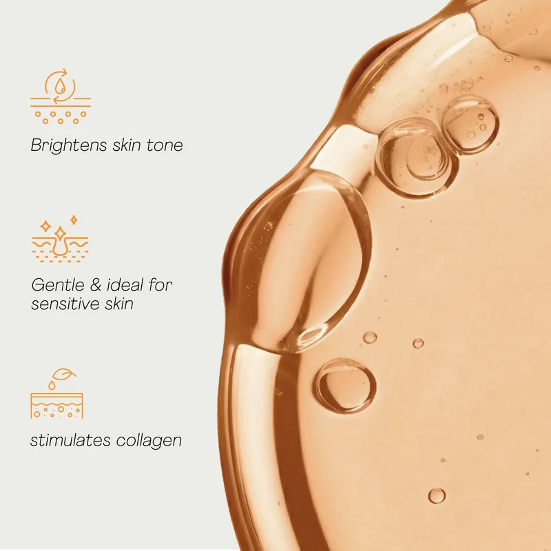 Close-up of a skincare product with benefits listed on a light background