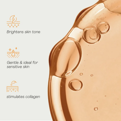 Close-up of a skincare product with benefits listed on a light background